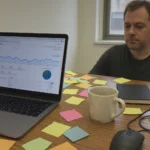 Cluttered desk with laptop and sticky notes